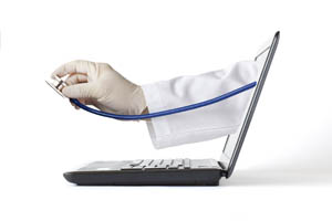 A doctor’s gloved hand holding a stethoscope emerges from a laptop screen, symbolizing online healthcare or telemedicine services.